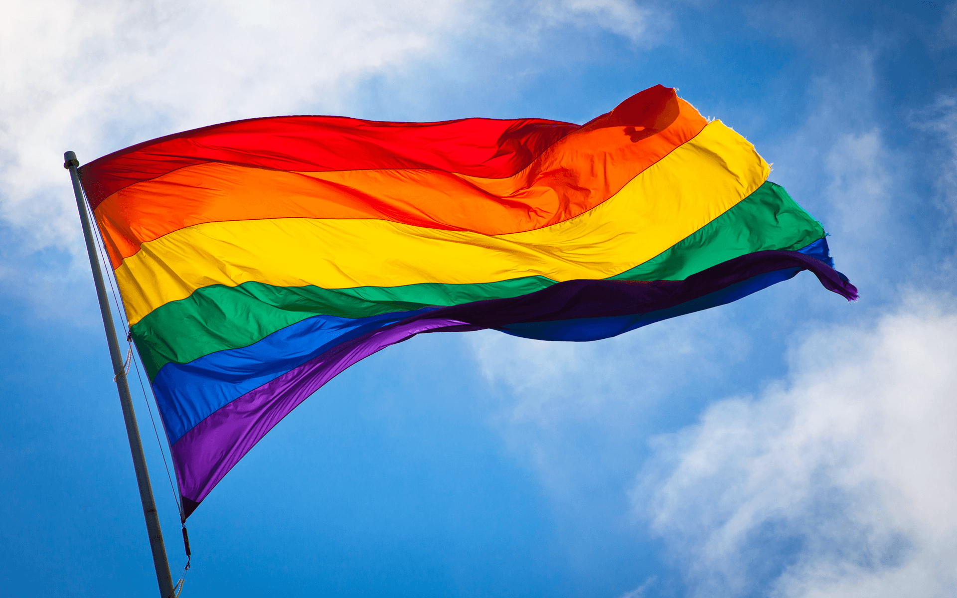 A pride flag waving in the breeze