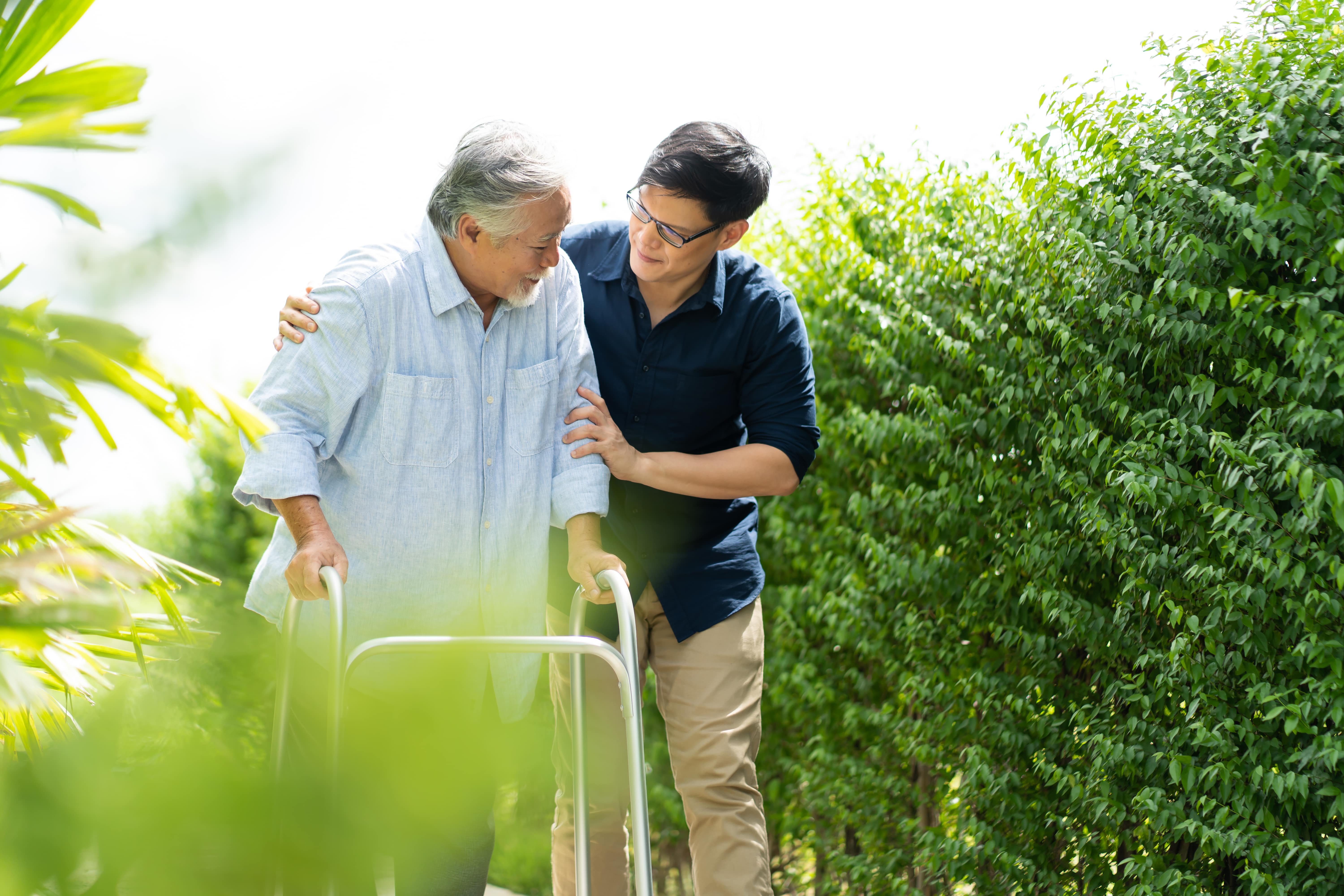 A caregiver helping his older loved one