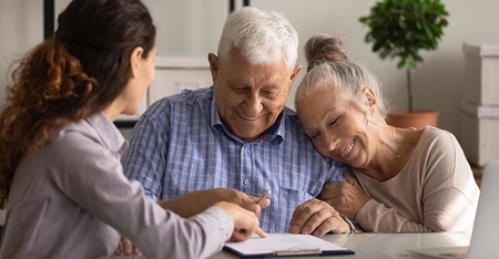 An older couple working together with a housing counselor