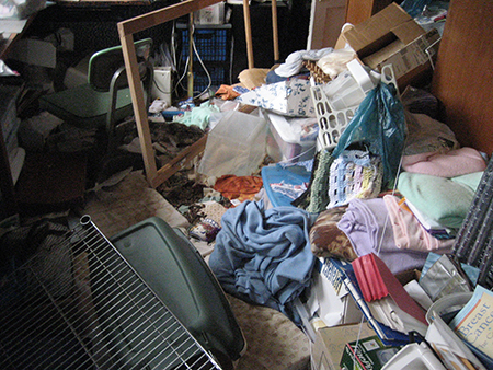 Hoarding Connection-household items and clothing on the floor.