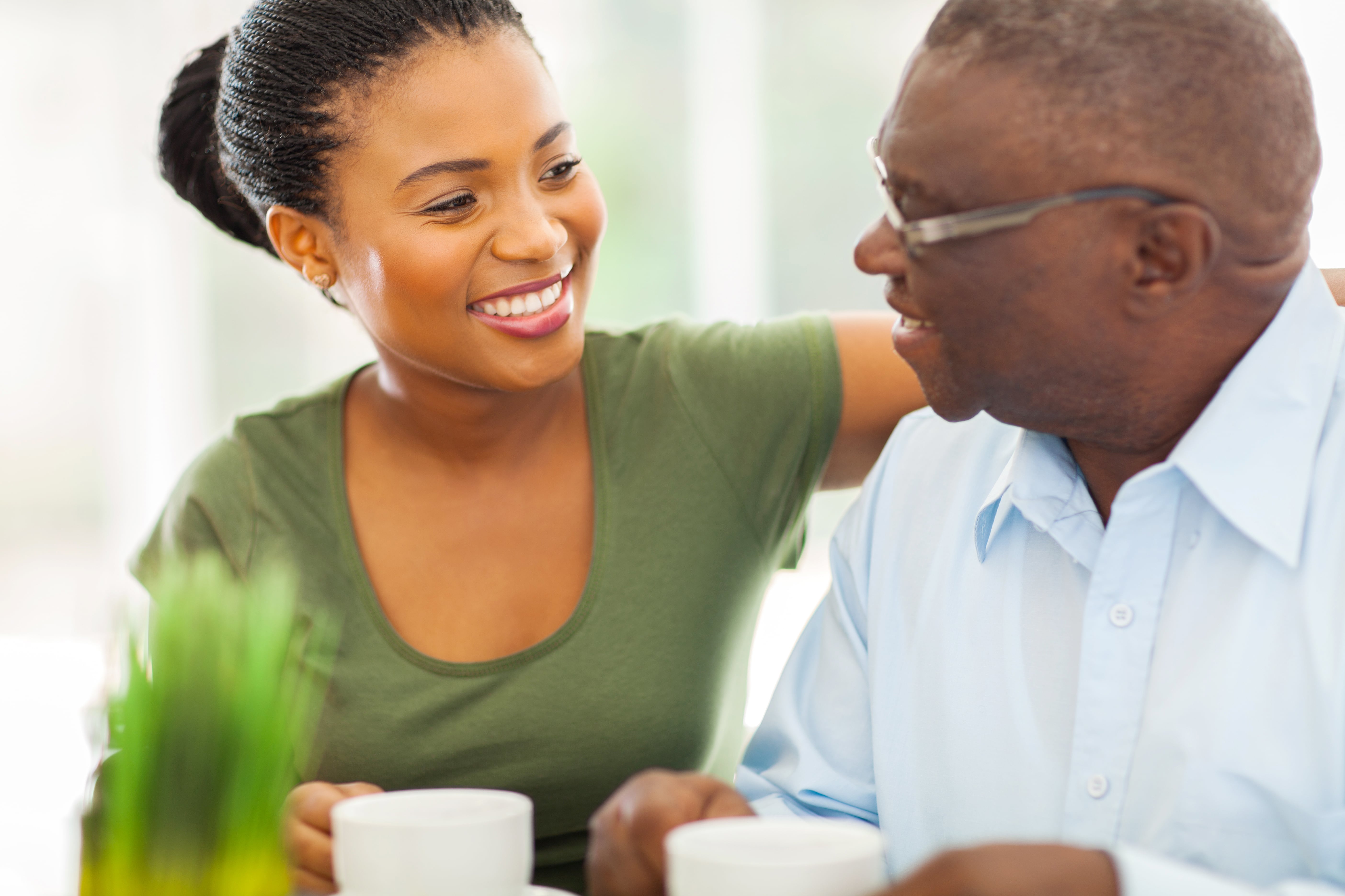 A caregiver chatting with her older adult father