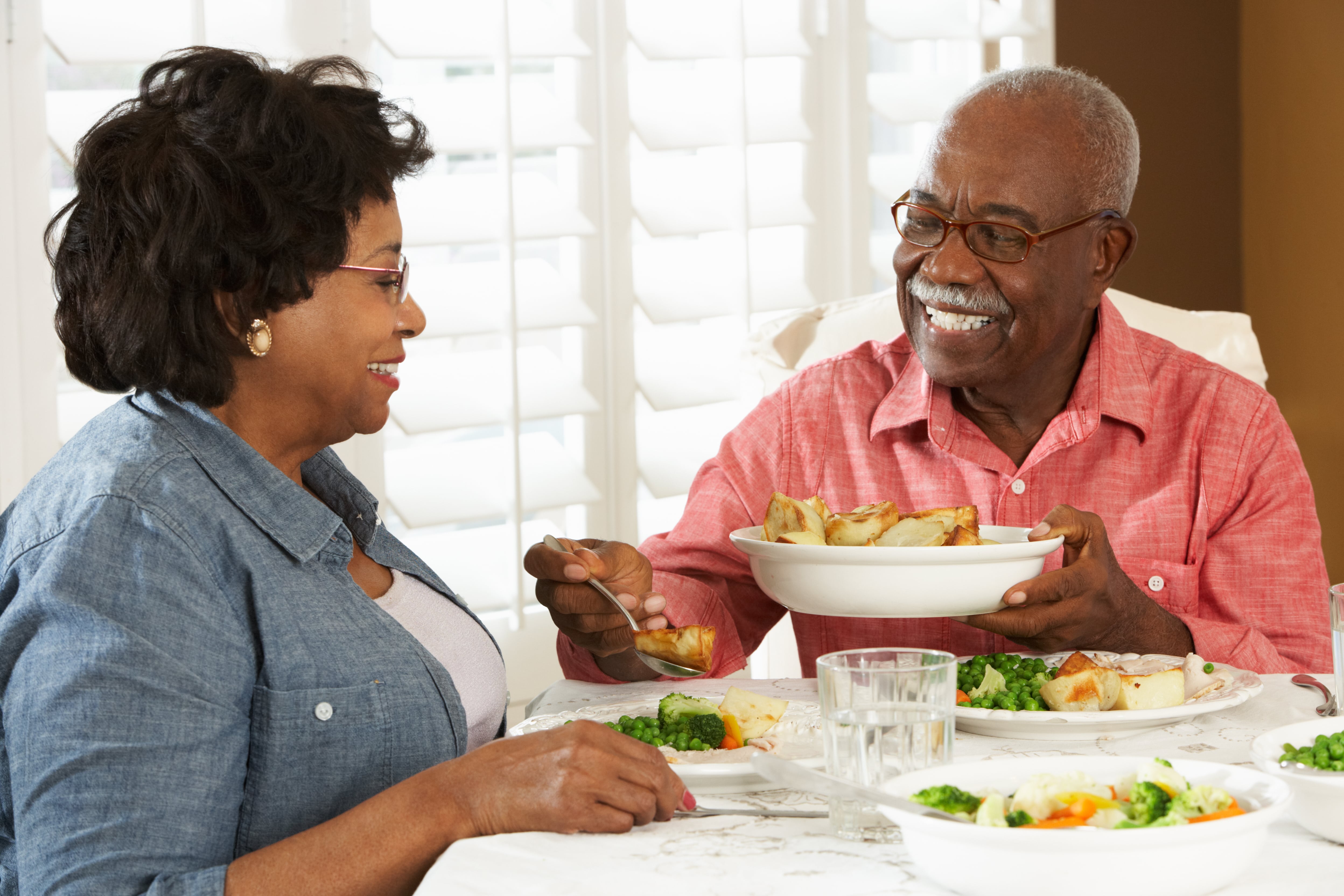 Two older adults sharing a meal together