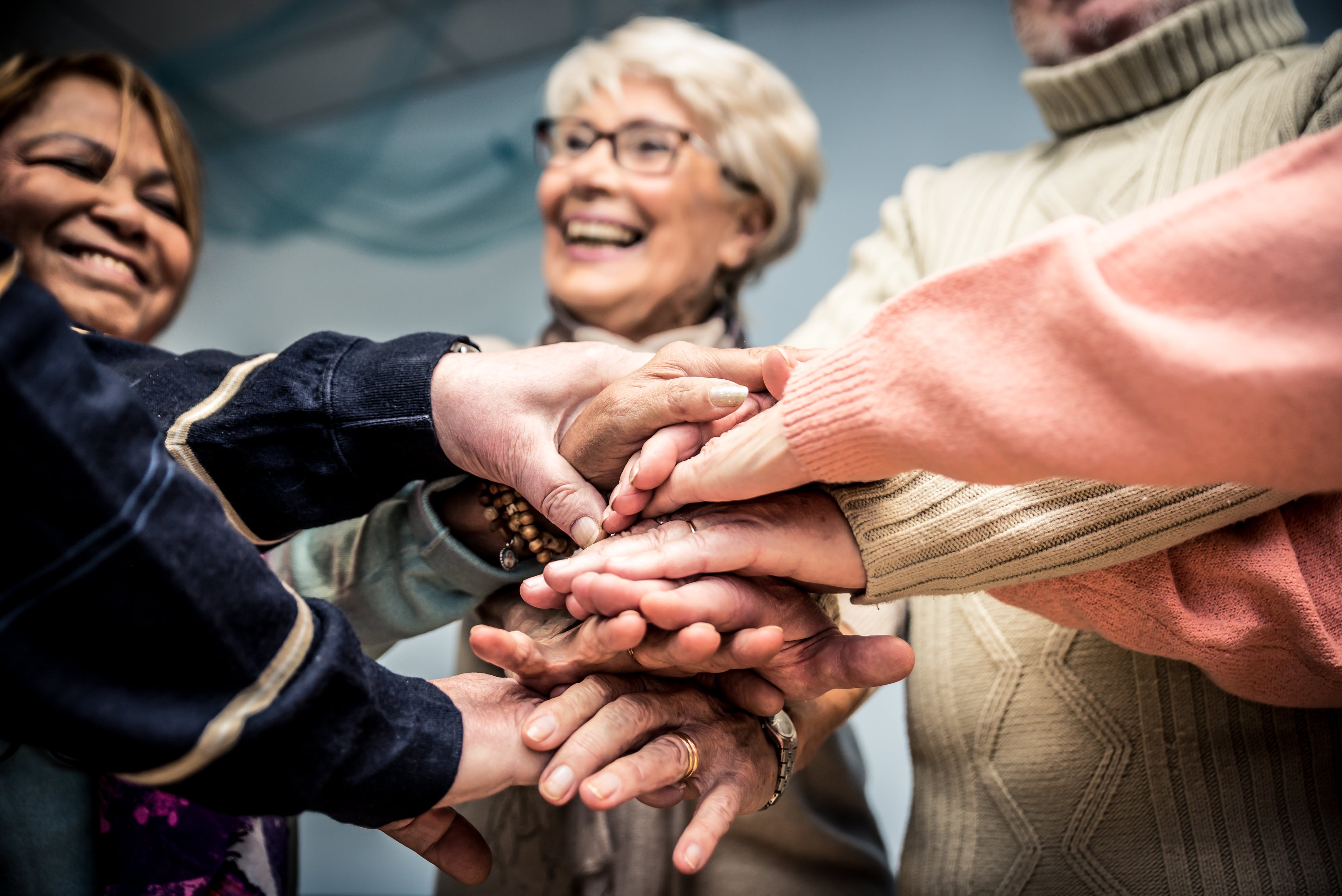 Older adults and loved ones joining hands– we're all in this together!