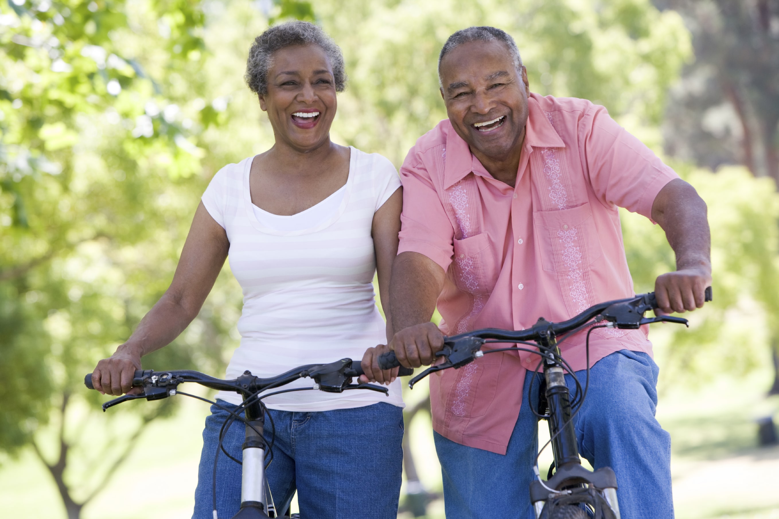 An older couple biking together