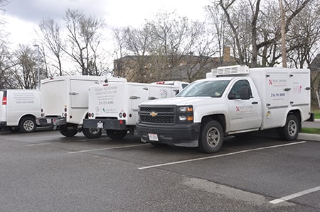 Four Rose Centers for Aging Well home-delivered meals trucks parked in a lot.