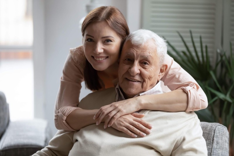 A caregiver embracing an older loved one